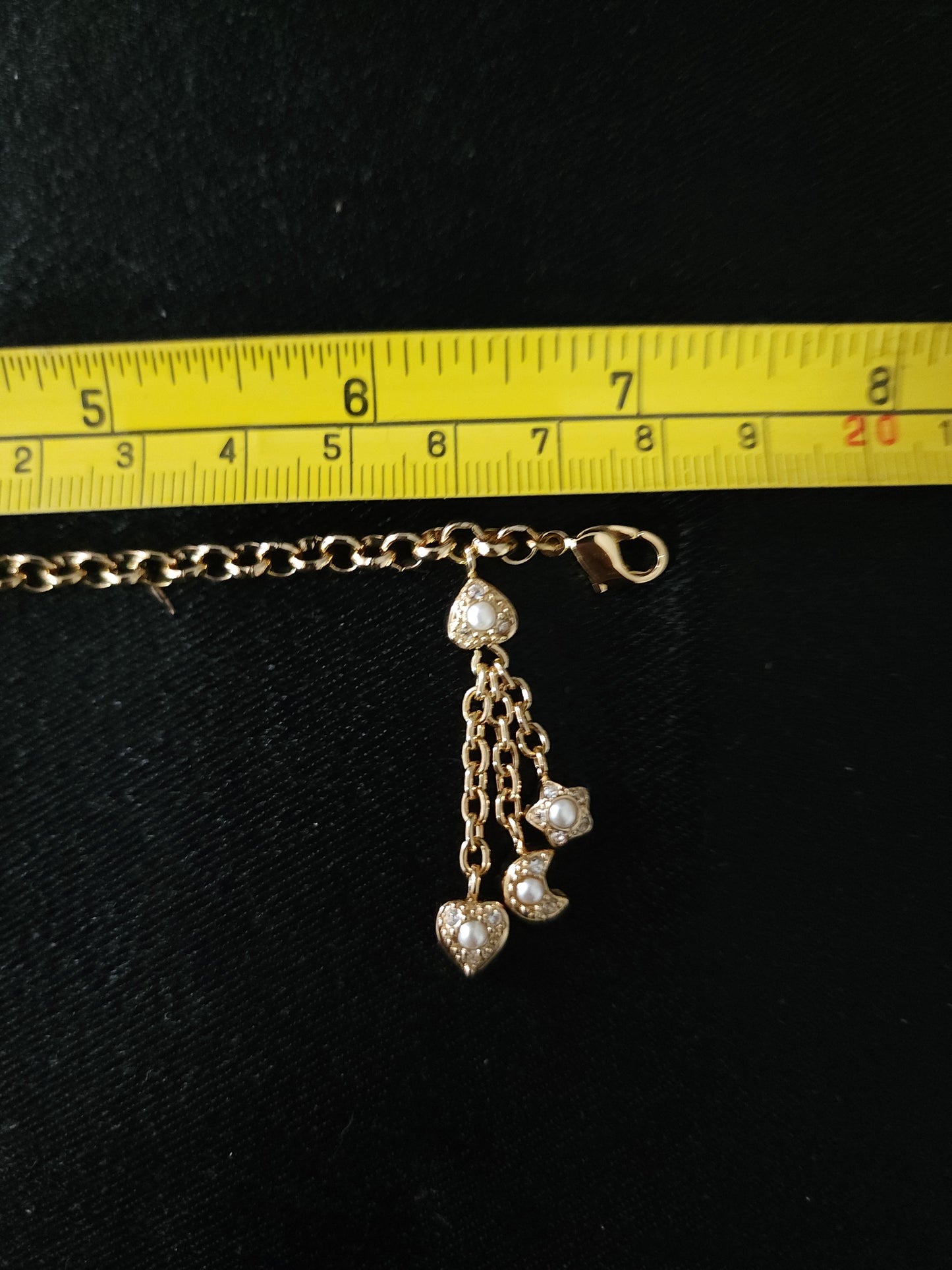 Christian Dior gold tone bracelet with dangling charms heart star moon