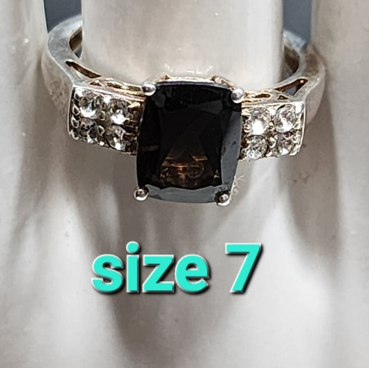 Sterling silver ring with Brown and clear stones size 7 maker is STS