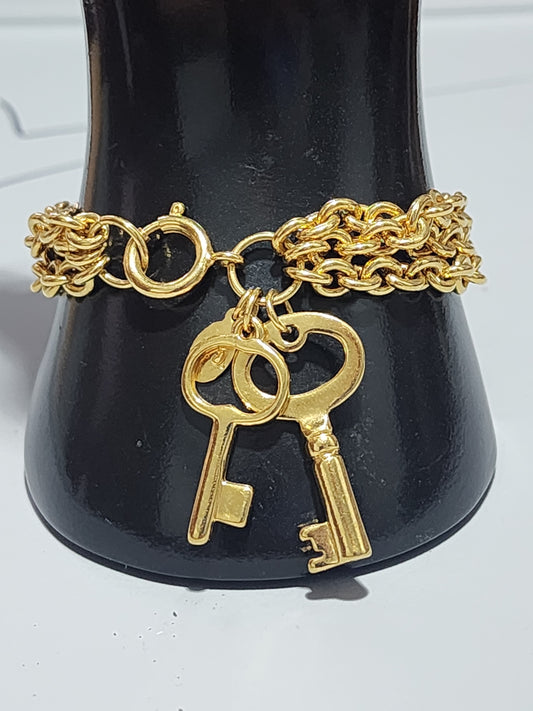 Premiere designs gold tone three strand bracelet with keys